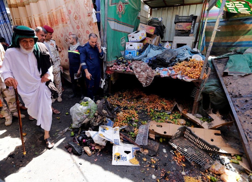 REFILE - CORRECTING GRAMMAR A man walks at a crowded market where a bomb went off in Baghdad's Sadr City district, Iraq August 14, 2018. REUTERS/Wissm al-Okili