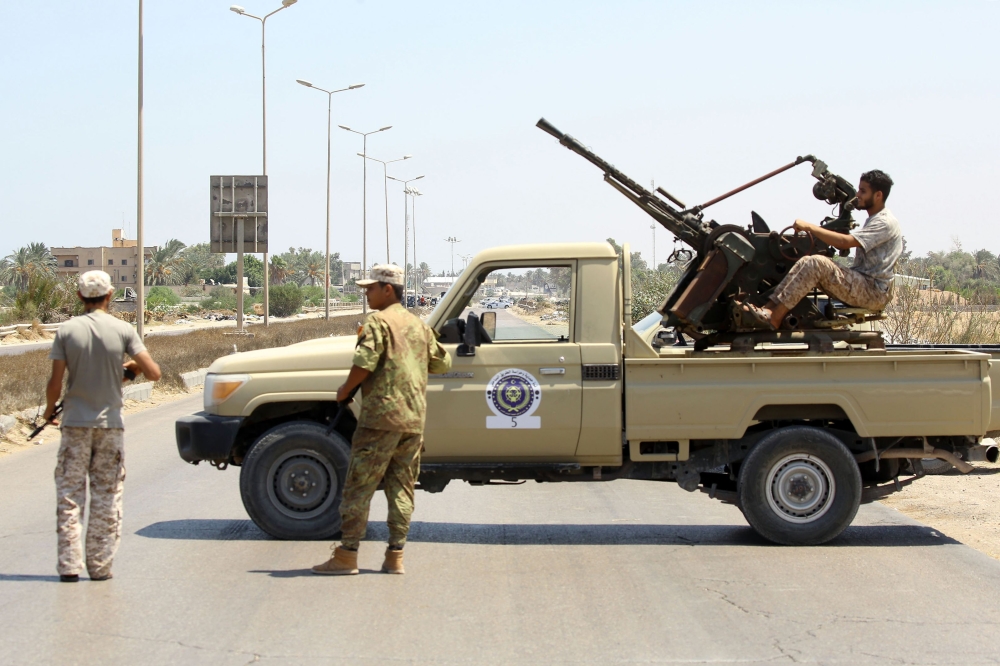 Libyans security forces stand guard at a checkpoint on August 23, 2018 at the site of an attack on a checkpoint in the city of Zliten, 170 km east of the capital Tripoli. An attack on a checkpoint between the Libyan capital and the town of Zliten killed four soldiers of the UN-backed unity government on today, the town's mayor said. / AFP / Mahmud TURKIA
