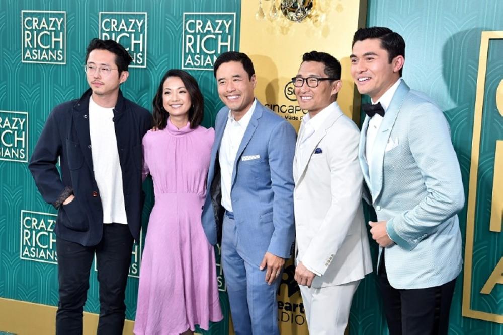 (FILES) In this file photo taken on August 7, 2018 Steven Yeun, Jae Suh Park, Randall Park, Daniel Dae Kim and Henry Golding attend the premiere of Warner Bros. Pictures' 