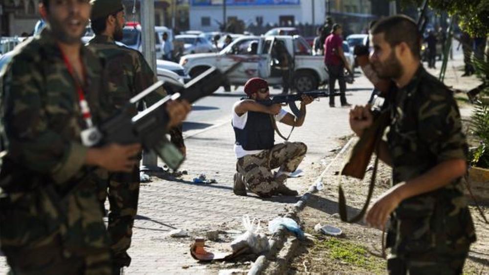 Libyan National Transitional Council (NTC) fighters deploy in the Abu Salim district of the Libyan capital Tripoli on October 14, 2011 after a gun battle erupted between armed supporters of the ousted regime and NTC forces, an AFP correspondent reported. AFP PHOTO / MARCO LONGARI (Photo credit should read MARCO LONGARI/AFP/Getty Images)