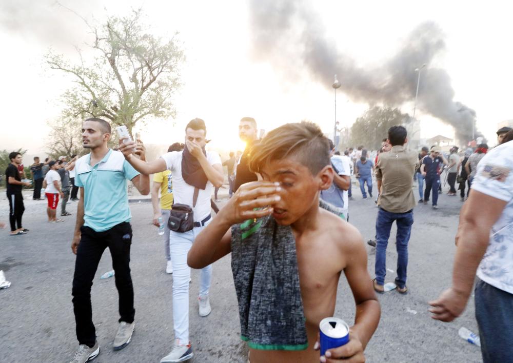 



 عراقي أصيب جراء إطلاق قوات الأمن الغاز المسيل للدموع خلال احتجاجات ضد الحكومة في مدينة البصرة، أمس الأول. (أ ف ب)