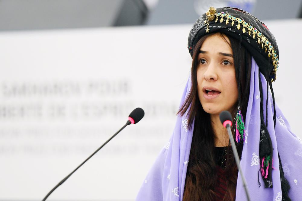 (FILES) In this file photo taken on December 13, 2016, Nadia Murad, public advocate for the Yazidi community in Iraq and survivor of sexual enslavement by the Islamic State jihadists, delivers a speech after being awarded co-laureate of the 2016 Sakharov human rights prize at the European parliament in Strasbourg. Along with Congolese gynecologist Denis Mukwege, public advocate for the Yazidi community in Iraq and survivor of sexual enslavement by the Islamic State jihadist Nadia Murad was awarded the 2018 Nobel Peace Prize on October 5, 2018. / AFP / FREDERICK FLORIN