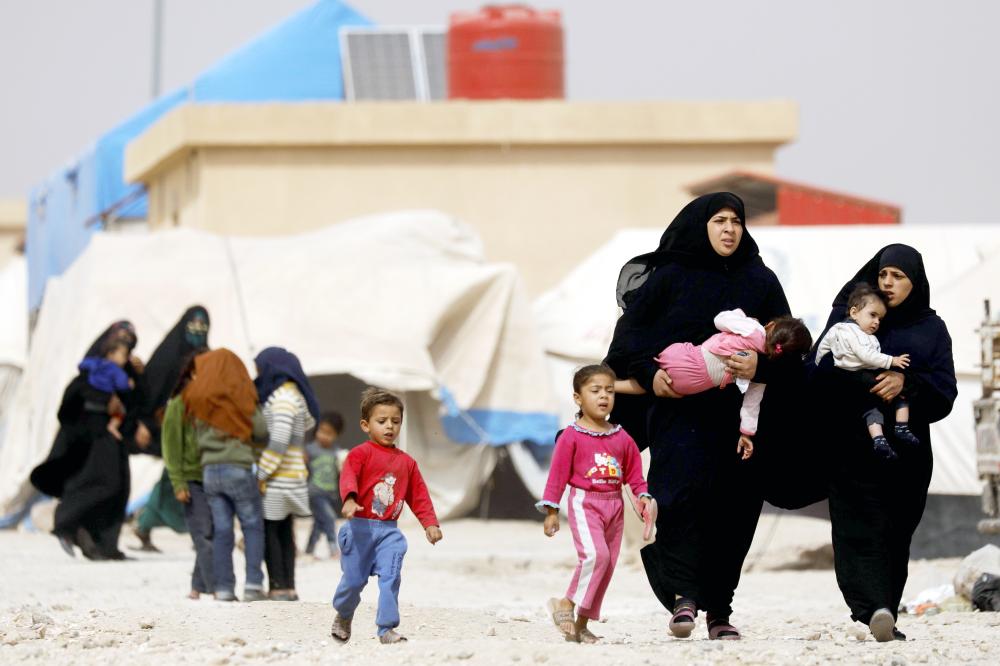 Displaced Syrians, from the eastern city of Deir Ezzor and Raqa who were forced to leave by the war against the Islamic State (IS) group, are pictured walking around at the Ain Issa camp on October 17, 2018. Tens of thousands fled their homes in and around Raqa in the months that led up to US-backed forces ousting the jihadists from the northern city in October 2017.
One year on, most returned, but thousands of others from destroyed homes remain at a camp for the displaced in Ain Issa, around 50 kilometres (30 miles) north of the ravaged city.
Families still reside in flimsy white tents, often with brightly coloured laundry slung out to dry on their guy ropes. / AFP / Delil souleiman
