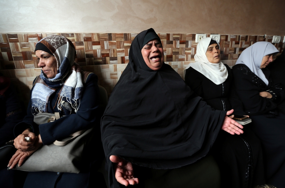 The stepmother of Palestinian teen Abdul Rauf Salha reacts during his funeral in the northern Gaza Strip January 14, 2019. REUTERS/Ibraheem Abu Mustafa