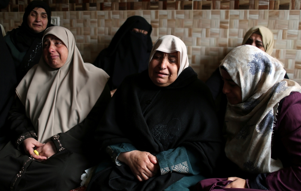 The mother of Palestinian teen Abdul Rauf Salha grieves during his funeral in the northern Gaza Strip January 14, 2019. REUTERS/Ibraheem Abu Mustafa