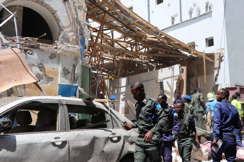 Security personel secure the scene of a car-bomb attack on February 4, 2019 in Somalia capital Mogadishu's Hamarwayne District. At least nine people were killed and several wounded when a car loaded with explosives blew up near a mall in a busy market in the Somali capital on Monday, police said. / AFP / ABDIRAZAK HUSSEIN FARAH 