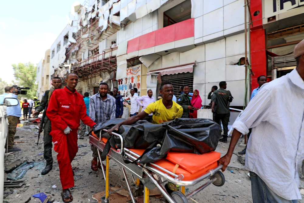 Somali emergency services evacuate a body from the scene where a car bomb exploded at a shopping mall in Mogadishu, Somalia February 4, 2019. REUTERS/Feisal Omar