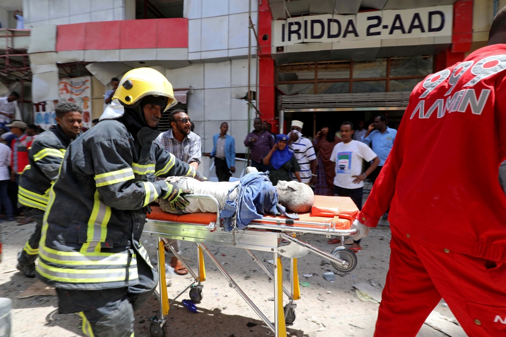 ATTENTION EDITORS - VISUAL COVERAGE OF SCENES OF INJURY OR DEATH Somali emergency services evacuate an injured man from the scene where a car bomb exploded at a shopping mall in Mogadishu, Somalia February 4, 2019. REUTERS/Feisal Omar TEMPLATE OUT