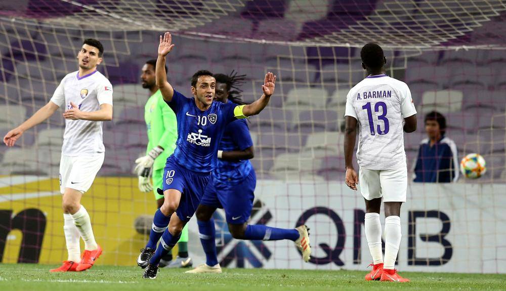 Hilal's midfielder Mohammad Al-Shalhoub (C) celebrates after scoring during the AFC champions league Group C football match between UAE's Al-Ain and Saudi Arabia's Al Hilal at the Hazza Bin Zayed Stadium in Al-Ain on March 5, 2019.  / AFP / -
