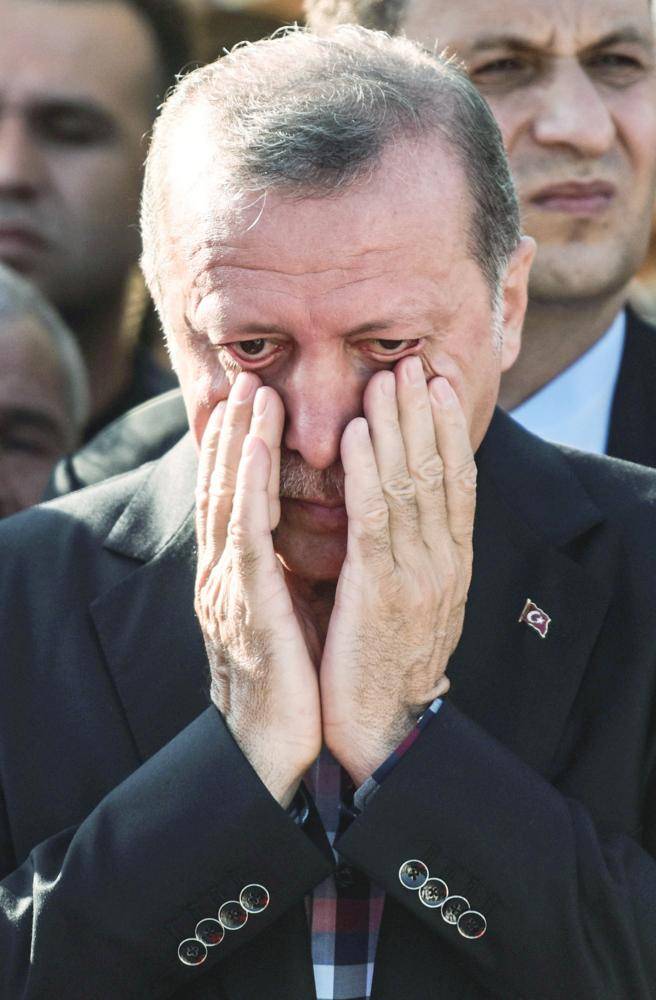 Turkey's President Recep Tayyip Erdogan reacts after attending the funeral of a victim of the coup attempt in Istanbul on July 17, 2016. 
Turkish President Recep Tayyip Erdogan vowed today to purge the 