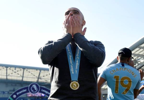 Soccer Football - Premier League - Brighton & Hove Albion v Manchester City - The American Express Community Stadium, Brighton, Britain - May 12, 2019  Manchester City manager Pep Guardiola celebrates winning the Premier League               REUTERS/Toby Melville  EDITORIAL USE ONLY. No use with unauthorized audio, video, data, fixture lists, club/league logos or 