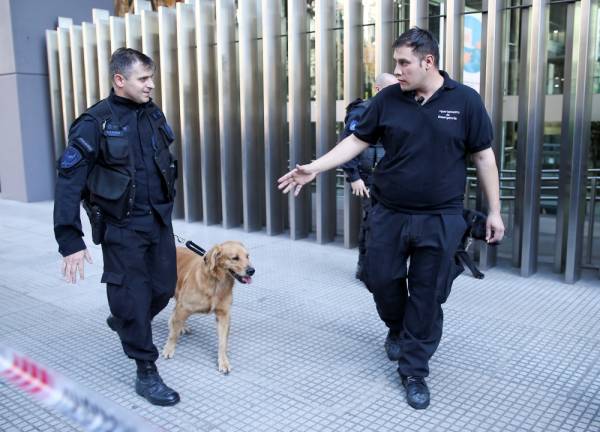 Police officers with a work dog walk outside the National Congress after bomb threats in Buenos Aires, Argentina May 13, 2019. REUTERS/Agustin Marcarian