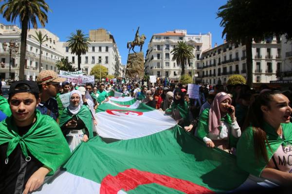 Students carry national flags during a protest demanding the removal of the ruling elite in Algiers, Algeria June 11, 2019. REUTERS/Ramzi Boudina