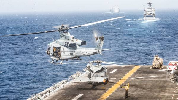 A UH-1Y Venom helicopter with Marine Medium Tiltrotor Squadron (VMM) 163 (Reinforced), 11th Marine Expeditionary Unit (MEU), takes off from the flight deck of the amphibious assault ship USS Boxer (LHD 4) during its transit through Strait of Hormuz in Gulf of Oman, Arabian Sea, July 18, 2019. Picture taken July 18, 2019. Dalton Swanbeck/U.S. Navy/Handout via REUTERS ATTENTION EDITORS- THIS IMAGE HAS BEEN SUPPLIED BY A THIRD PARTY.