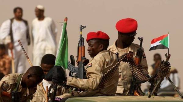 FILE PHOTO: Paramilitary Rapid Support Forces (RSF) soldiers secure the area as they wait for the arrival of Lieutenant General Mohamed Hamdan Dagalo, deputy head of the military council and head of RSF, before a meeting in Aprag village, 60 kilometers away from Khartoum, Sudan, June 22, 2019. REUTERS/Umit Bektas/File Photo - RC1162C984E0