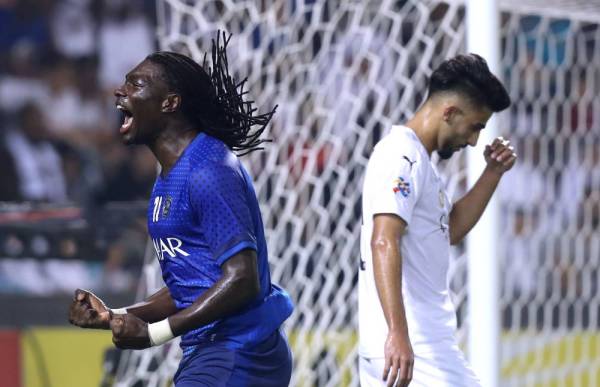 Hilal's forward Bafetimbi Gomis (R) celebrates after scoring a goal during the first leg of the AFC Champions League semi-finals football match between Qatar's Al Sadd and Saudi' Al Hilal at the Jassim bin Hamad Stadium in the Qatari capital Doha, on October 1, 2019. / AFP / Karim JAAFAR
