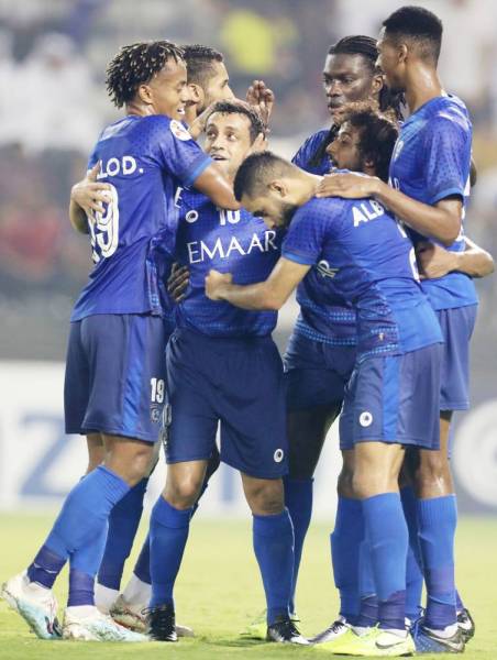 Hilal's players celebrate a goal during the first leg of the AFC Champions League semi-finals football match between Qatar's Al Sadd and Saudi' Al Hilal at the Jassim bin Hamad Stadium in the Qatari capital Doha, on October 1, 2019. / AFP / Karim JAAFAR
