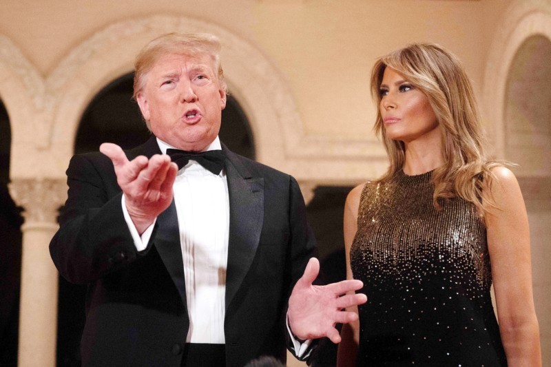 US President Donald Trump and First Lady Melania Trump speak to the press outside the grand ballroom as they arrive for a New Year's celebration at Mar-a-Lago in Palm Beach, Florida, on December 31, 2019. / AFP / JIM WATSON
