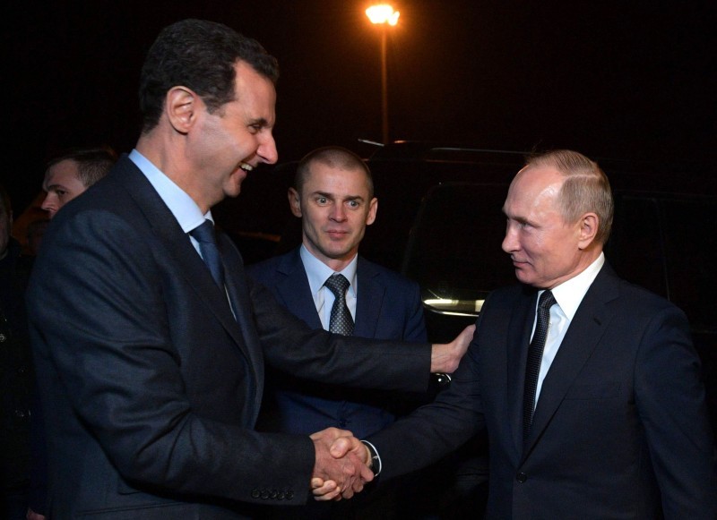 Russian President Vladimir Putin and Syrian President Bashar al-Assad shake hands after their meeting in Damascus on January 7, 2020. Putin met his Syrian counterpart Bashar al-Assad during an unprecedented visit to Damascus as the prospect of war between Iran and the United States loomed over the region. / AFP / SPUTNIK / Alexey DRUZHININ
