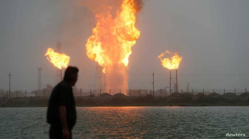 Man looks at flames rising from oil refinery pipes in Basra, Iraq July 23, 2020. Picture taken July 23, 2020. REUTERS/Essam al-Sudani