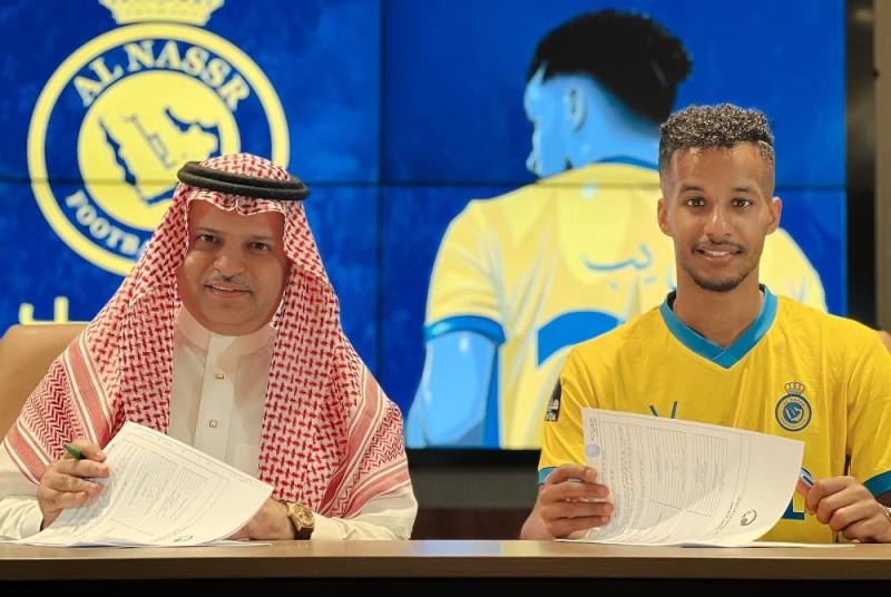 رئيس مجلس إدارة نادي النصر مسلي آل معمر واللاعب عبدالرحمن غريب أثناء التوقيع (المركز الإعلامي بنادي النصر)