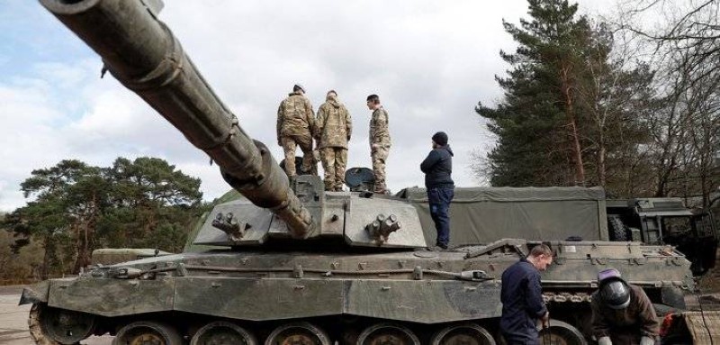 Soldiers work on a Challenger 2 main battle tank during during the Royal Electrical & Mechanical Engineers’ training exercise called 