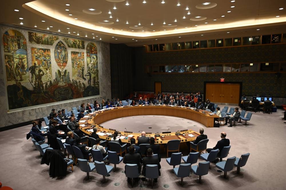 (FILES) In this file photo German Foreign Minister Heiko Maas (C) speaks at a UN Security Council meeting at United Nations headquarters in New York on February 26, 2020. - After more than a month of controversy, a UN Security Council buffeted between the United States, China and Russia is finally expected this week of April 27, to adopt its first resolution on the coronavirus pandemic, amid calls for intensified international cooperation. (Photo by Johannes EISELE / AFP)