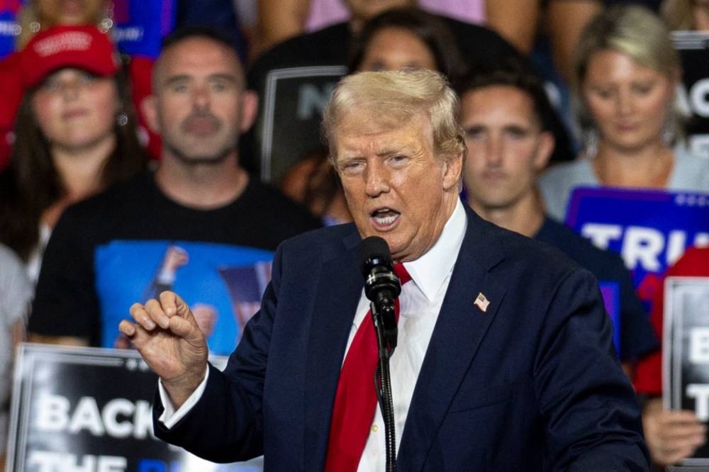 Former US President and 2024 Republican presidential candidate Donald Trump gestures as he speaks during a campaign rally at the Bojangles Coliseum in Charlotte, North Carolina, on July 24, 2024. (Photo by Logan Cyrus / AFP)